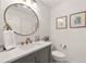 Stylish bathroom with a gray vanity, quartz countertop, and a round mirror at 1504 Parkaire Xing, Marietta, GA 30068