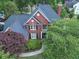 Brick house with gray roof, surrounded by lush green trees at 2592 Dunmoore Dr, Snellville, GA 30078