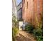 Backyard with grill and string lights between brick walls at 9129 Selborne Ln, Chattahoochee Hills, GA 30268