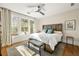 King bedroom with hardwood floors and large windows at 9129 Selborne Ln, Chattahoochee Hills, GA 30268