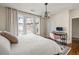 Bright bedroom with king bed and workspace, hardwood floors at 9129 Selborne Ln, Chattahoochee Hills, GA 30268