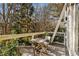 Private deck with table and chairs, overlooking wooded area at 9129 Selborne Ln, Chattahoochee Hills, GA 30268