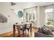 Well-lit dining area with a rustic wooden table and four black metal chairs at 9129 Selborne Ln, Chattahoochee Hills, GA 30268