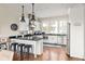 Modern kitchen with white cabinets, dark countertops, and stainless steel appliances at 9129 Selborne Ln, Chattahoochee Hills, GA 30268