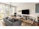 Bright and airy living room with hardwood floors and access to a balcony at 9129 Selborne Ln, Chattahoochee Hills, GA 30268