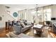 Open concept living space with hardwood floors, large windows, and a dining area at 9129 Selborne Ln, Chattahoochee Hills, GA 30268