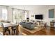 Spacious living area features hardwood floors, a comfortable sofa, and a large TV at 9129 Selborne Ln, Chattahoochee Hills, GA 30268