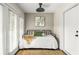 Bright sunroom with daybed and access to private patio at 9129 Selborne Ln, Chattahoochee Hills, GA 30268