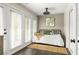 Bright sunroom with daybed and access to private patio at 9129 Selborne Ln, Chattahoochee Hills, GA 30268