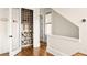 Built-in wine cellar with ample storage and a wooden ladder at 9129 Selborne Ln, Chattahoochee Hills, GA 30268