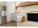 White brick fireplace with a wood mantel in living room at 336 Mont Harmony Sw Rd, Powder Springs, GA 30127