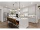 Modern kitchen with white cabinets, large island, and stainless steel appliances at 336 Mont Harmony Sw Rd, Powder Springs, GA 30127