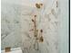 Walk-in shower with marble tile and gold fixtures at 336 Mont Harmony Sw Rd, Powder Springs, GA 30127