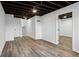 Finished basement with grey wood-look flooring and an open floor plan at 4051 Glenda Dr, College Park, GA 30337