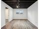 Finished basement room with two windows and wood-look flooring at 4051 Glenda Dr, College Park, GA 30337