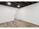 Finished basement room with door leading to other rooms and wood-look flooring at 4051 Glenda Dr, College Park, GA 30337