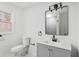 Updated bathroom with grey vanity, marble floor, and window at 4051 Glenda Dr, College Park, GA 30337