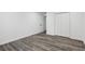 Spacious bedroom with grey wood-look flooring and ample closet space at 4051 Glenda Dr, College Park, GA 30337