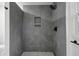 Large walk-in shower with grey tiles and built-in shelves at 4051 Glenda Dr, College Park, GA 30337