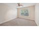 Bright bedroom with ceiling fan, large window, and neutral carpeting at 2130 Cooper Lakes Dr, Grayson, GA 30017