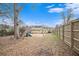 Fenced backyard with playset, trees, and a view of the house at 61 Macland Springs Dr, Dallas, GA 30157