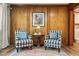 Cozy sitting area with wood-paneled walls, two armchairs, and stylish rug at 3144 Willow Grove Se Cir, Marietta, GA 30067