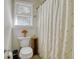 Simple bathroom with toilet, shower, and a window at 2230 Old Fountain Rd, Lawrenceville, GA 30043