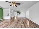 Living area with gleaming wood-look floors, ceiling fan, and open concept layout at 3648 Silver Springs Ct, Decatur, GA 30034