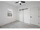 Spacious bedroom featuring hardwood floors, a barn door, and a window at 1097 Hubbard Sw St, Atlanta, GA 30310
