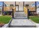 Modern concrete steps lead to a charming front porch with wooden railings at 1097 Hubbard Sw St, Atlanta, GA 30310