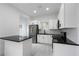 Modern kitchen with white cabinets, black countertops, and stainless steel appliances at 1097 Hubbard Sw St, Atlanta, GA 30310