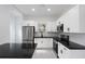 Modern kitchen with white cabinets, black countertops, and stainless steel appliances at 1097 Hubbard Sw St, Atlanta, GA 30310