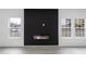 Bright living room features a modern fireplace and wood-look floors at 1097 Hubbard Sw St, Atlanta, GA 30310