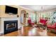 Sunken living room with hardwood floors, fireplace, and wicker furniture at 4230 Thayer Dr, Powder Springs, GA 30127