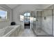 Spacious Primary bathroom featuring tiled shower, soaking tub, and view of the bedroom at 1470 Stone Lea Dr, Oxford, GA 30054