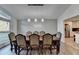 Dining room with wood floors, large windows, and a long wooden dining table with upholstered chairs at 1470 Stone Lea Dr, Oxford, GA 30054