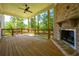 Spacious back porch with a fireplace, wooden deck, and tranquil wooded views at 119 Terrace View Dr, Acworth, GA 30101