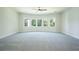 Large bedroom with bay windows, plush carpet, and a ceiling fan at 119 Terrace View Dr, Acworth, GA 30101