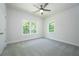 Bright bedroom with two large windows, carpeted flooring, and a ceiling fan at 119 Terrace View Dr, Acworth, GA 30101