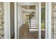View from foyer into living room with hardwood floors and staircase at 119 Terrace View Dr, Acworth, GA 30101