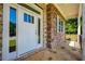 Inviting front porch with white door, stone accents, and flagstone flooring at 119 Terrace View Dr, Acworth, GA 30101