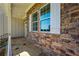 Front porch featuring stone walls, white shutters, and flagstone flooring at 119 Terrace View Dr, Acworth, GA 30101
