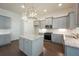 Kitchen island with granite countertop, gray cabinets, and stainless steel appliances at 119 Terrace View Dr, Acworth, GA 30101