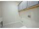 Laundry room with gray cabinets, patterned tile floor, and space for washer and dryer at 119 Terrace View Dr, Acworth, GA 30101
