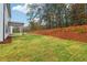 Private backyard with grassy area and wooded backdrop at 5388 Heron Bay Blvd, Locust Grove, GA 30248