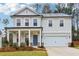 Two-story house with gray siding, blue door, and a landscaped yard at 5388 Heron Bay Blvd, Locust Grove, GA 30248