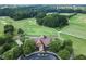 Aerial view of golf course clubhouse, surrounded by lush greenery at 5392 Heron Bay Blvd, Locust Grove, GA 30248