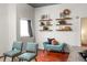 Living room with teal armchairs and floating shelves at 620 Glen Iris Ne Dr # 511, Atlanta, GA 30308