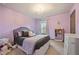 Charming purple bedroom with ample natural light, perfect for a or guest at 4958 Mcever View Dr, Sugar Hill, GA 30518