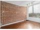 Room with exposed brick wall and a large glass block window at 1112 Delaware Se Ave, Atlanta, GA 30316